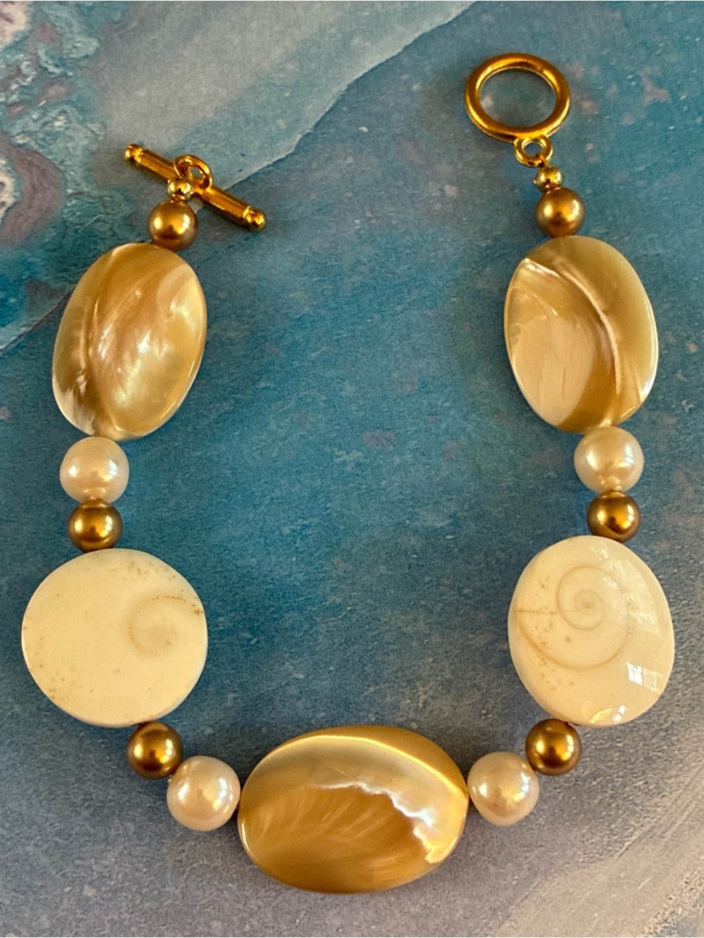 Hand crafted shell and mother of pearl toggle bracelet with faux pearls 7”